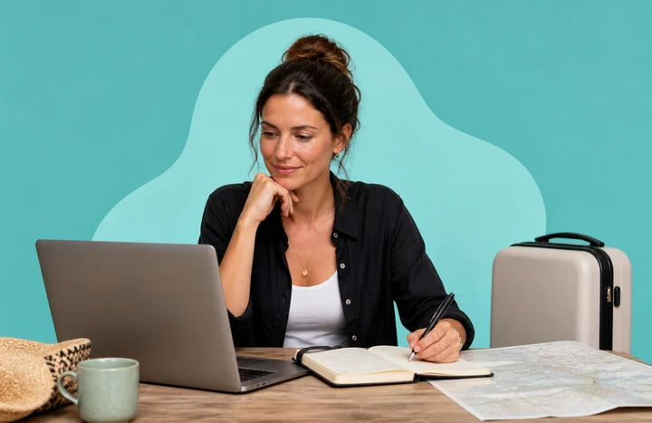 Woman planning a trip with a laptop, notebook, suitcase and map on a turquoise background